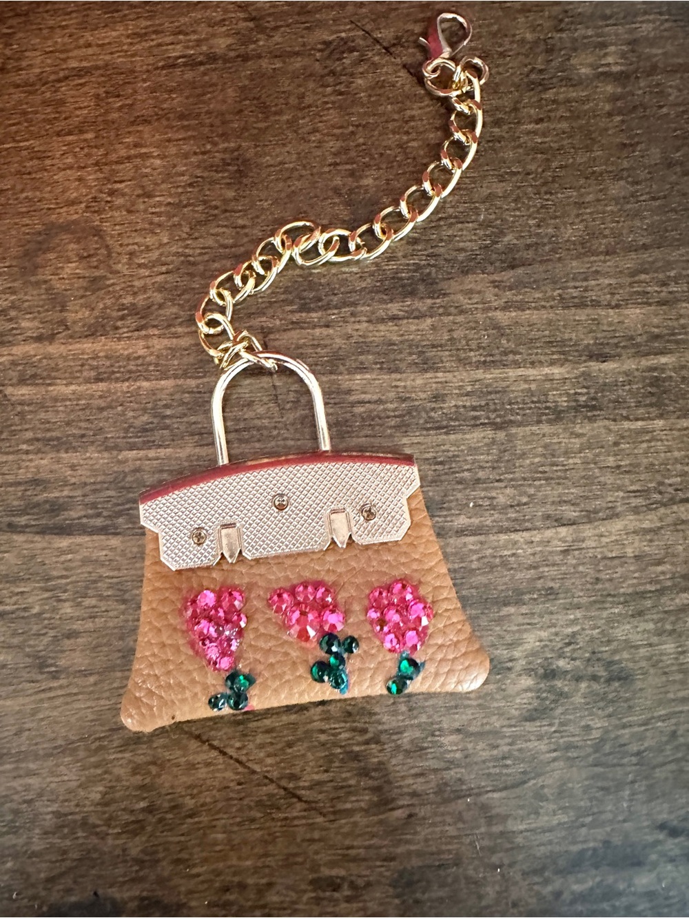 Embellished Tan Leatherette Charm Keychain with Bedazzled Pink Flower Accents.